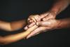 Hands of an old person and a child to show concept of solidarity 