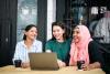 Three women using a laptop in a positive mood