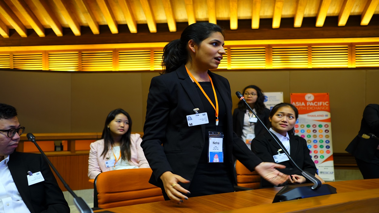         Young woman speaking at an event
      